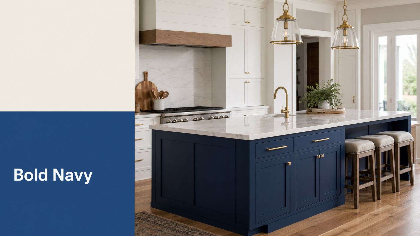 A modern kitchen interior featuring a large, bold navy blue island with gold hardware and white cabinets.